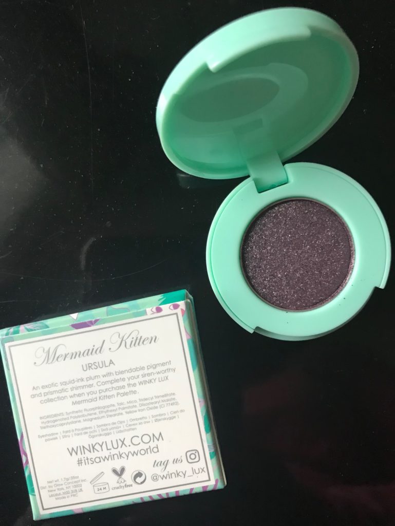 open eyeshadow compact to show the purple shimmer shade, Ursula, from the Winky Lux Mermaid Kitten palette, neversaydiebeauty.com