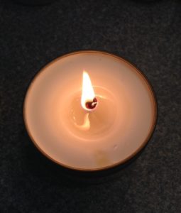 lit MojoSpa candle, burning to create body cream neversaydiebeauty.com