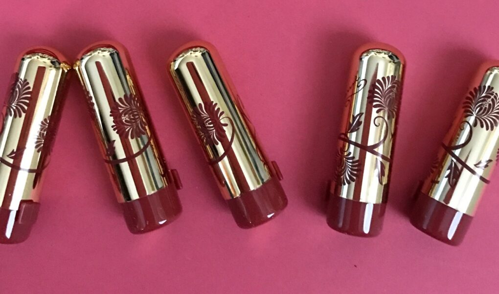 Besame Mini Lipsticks in gold cases with red flower decorations neversaydiebeauty.com