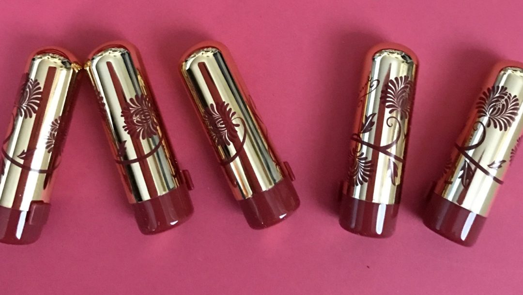 Besame Mini Lipsticks in gold cases with red flower decorations neversaydiebeauty.com