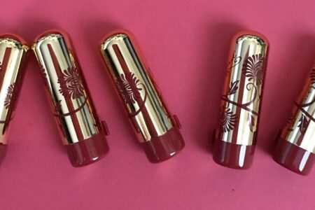 Besame Mini Lipsticks in gold cases with red flower decorations neversaydiebeauty.com