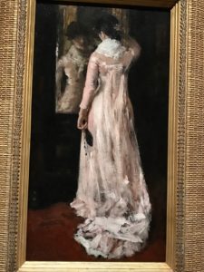 Woman Dressing to Go Out (pink dress), painting by William Merritt Chase at MFA exhibit