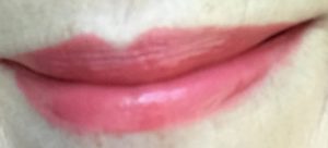 lip swatch of Revlon Ultra HD LipColor in shade Sunset 725, a pinky coral shade, neversaydiebeauty.com