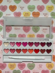 Wet N Wild Perfect Pout Lip Palette, open to show 16 heart-shaped gloss pans & lip brush, neversaydiebeauty.com