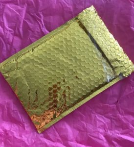 gold metallic mailing envelope from Ipsy, neversaydiebeauty.com