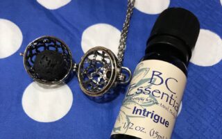 BC Essentials essential oil, Intrigue, along with a lava ball from an aromatherapy necklace, neversaydiebeauty.com