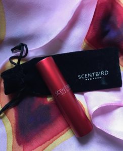 Scentbird's red atomizer on black felt pouch, neversaydiebeauty.com