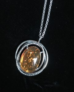 closeup of amber pendant with Sterling Silver from Uno Alla Volta, neversaydiebeauty.com