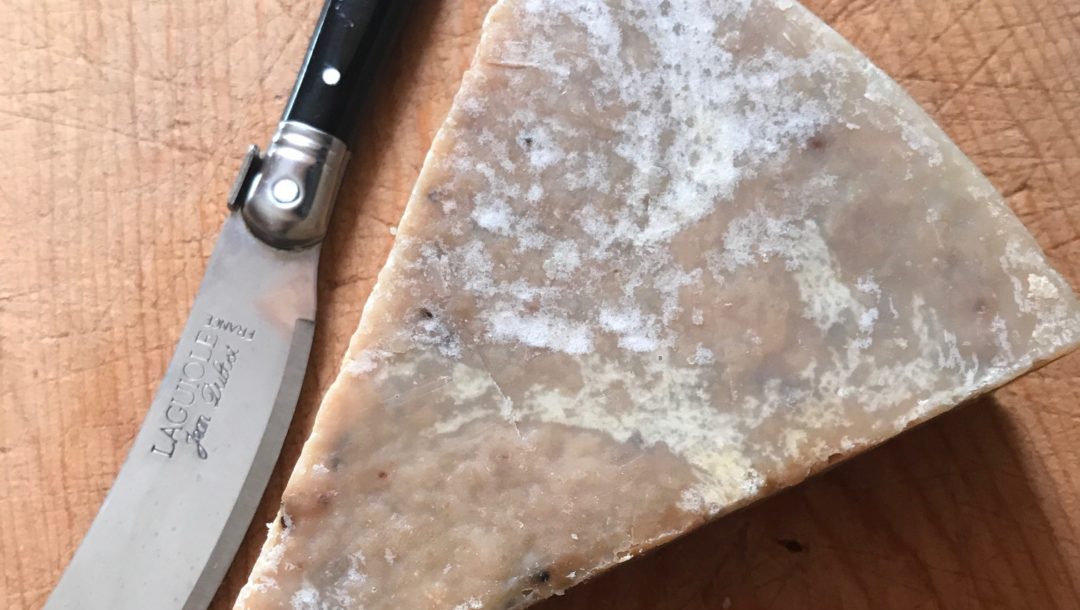 wedge-shaped unwrapped Farmhouse Fresh soap on a cutting board, neversaydiebeauty.com