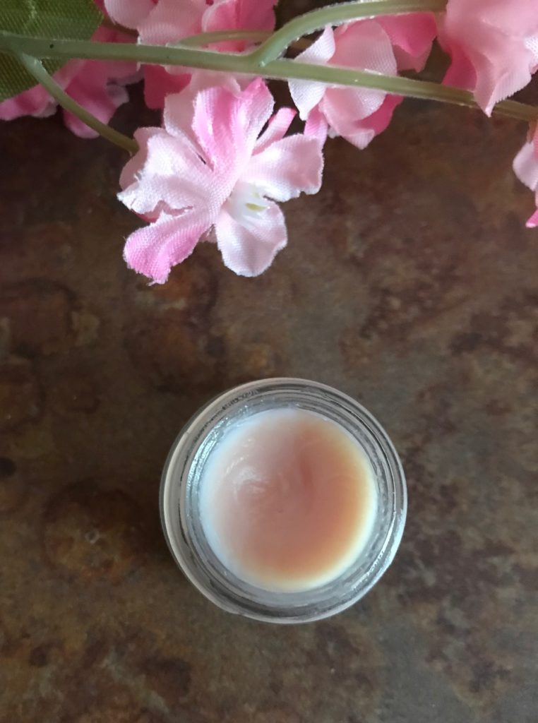 open jar of By Terry Baume de Rose showing the pale peachy-pink balm inside, neversaydiebeauty.com