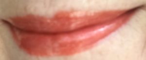 Jesse's Girl lipgloss "Astrid" worn atop an orange lipstick, neversaydiebeauty.com