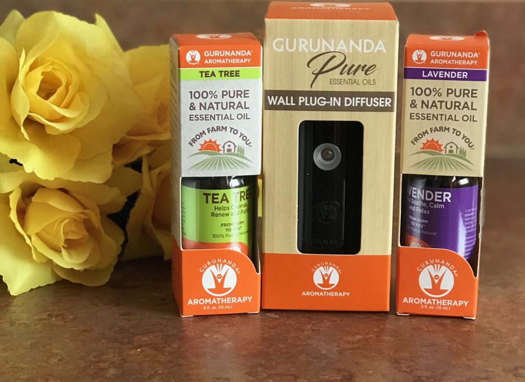 Gurunanda Natural Mist portable diffuser and lavender and tea tree essential oils in their outer packaging, neversaydiebeauty.com