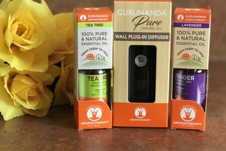 Gurunanda Natural Mist portable diffuser and lavender and tea tree essential oils in their outer packaging, neversaydiebeauty.com