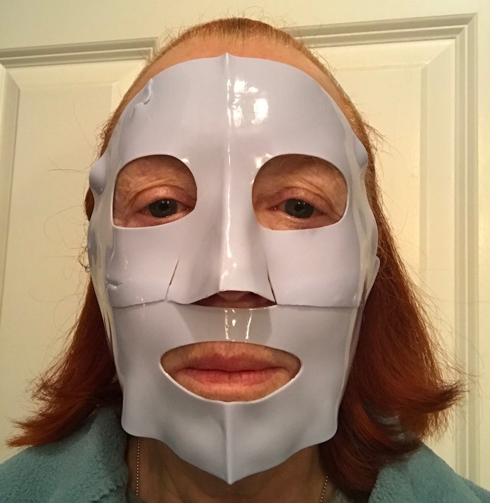 me wearing a blue rubber mask from Masqueology, neversaydiebeauty.com