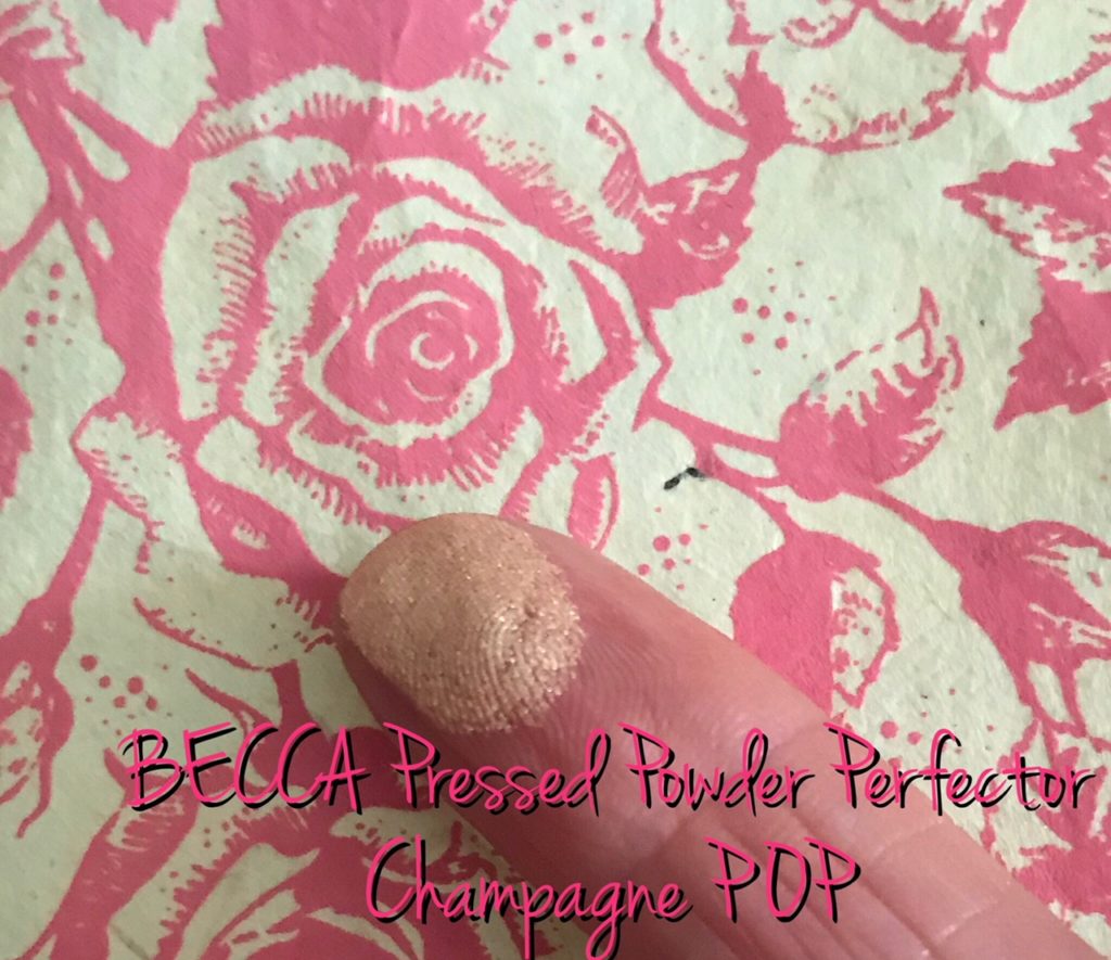 finger swatch of BECCA Pressed Powder Perfector in Champagne POP