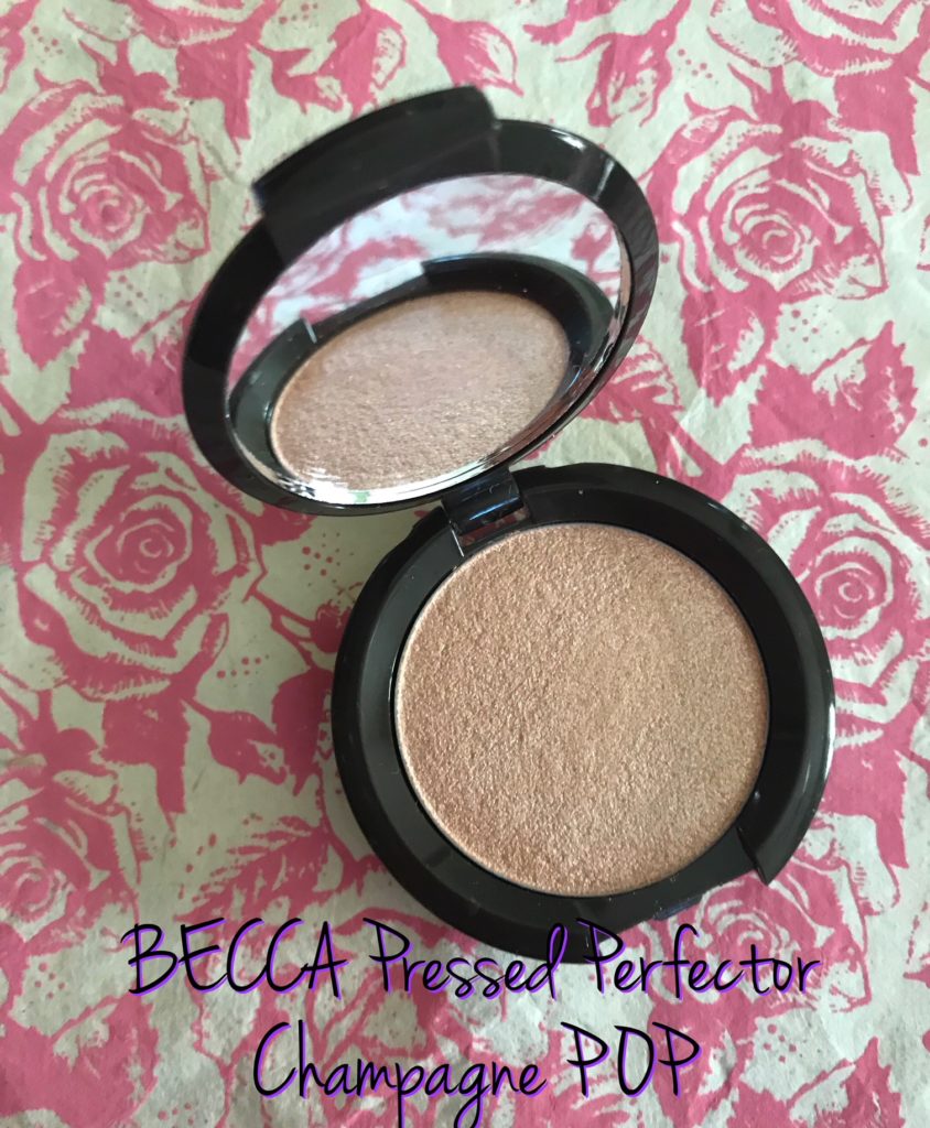 open compact of BECCA Pressed Powder Perfector in Champagne POP