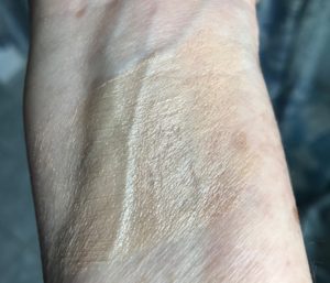 swatch of MyChelle Sun Shield Stick SPF 50 that appears golden before it's rubbed in, neversaydiebeauty.com
