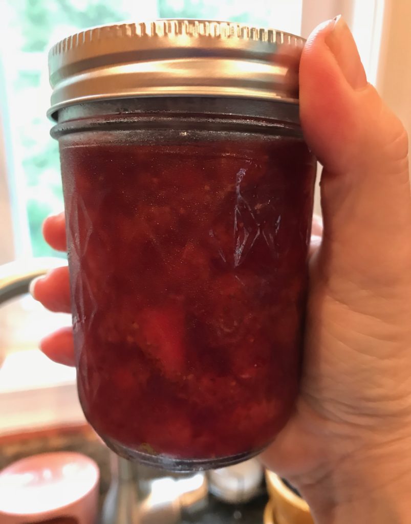 closeup of jam jar showing strawberries evenly distributed throughout the jam, neversaydiebeauty.com