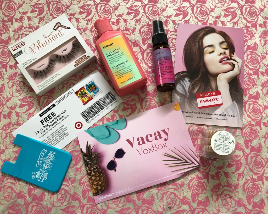 contents of my Influenster Vacay vox box with haircare products, false lashes, Invisibobbles, and candy coupons, neversaydiebeauty.com