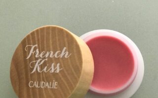 open pot of Caudalie French Kiss Tinted Lip Balm in natural pink shade, Innocence, neversaydiebeauty.com