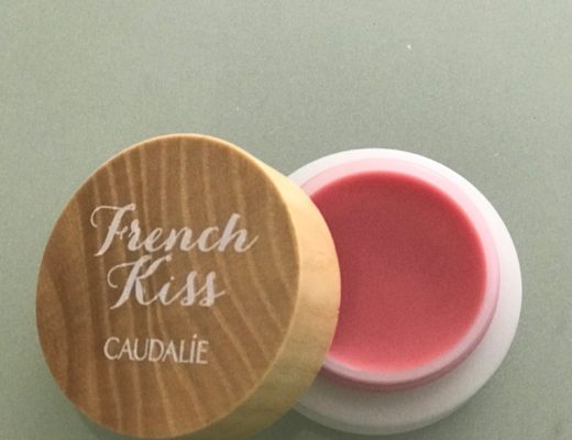 open pot of Caudalie French Kiss Tinted Lip Balm in natural pink shade, Innocence, neversaydiebeauty.com