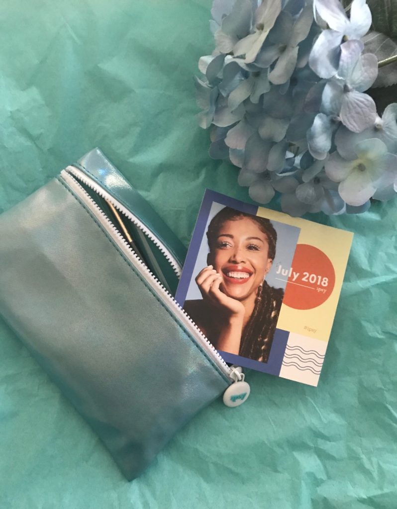 Ipsy bag for July 2018 with theme card, neversaydiebeauty.com
