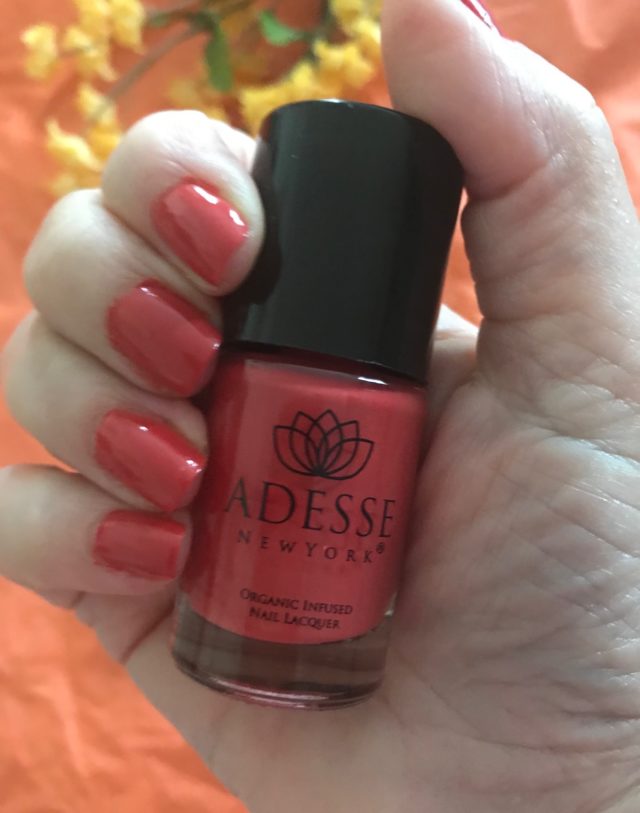 my nails wearing Adesse Organic Nail Lacquer in shade Parasol, a true coral, neversaydiebeauty.com