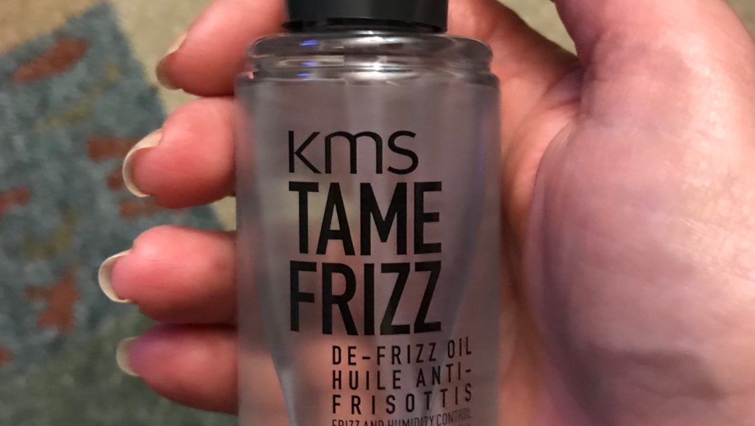 KMS Tame Frizz De-frizz Oil bottle showing the pump, neversaydiebeauty.com