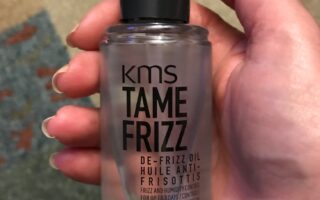 KMS Tame Frizz De-frizz Oil bottle showing the pump, neversaydiebeauty.com