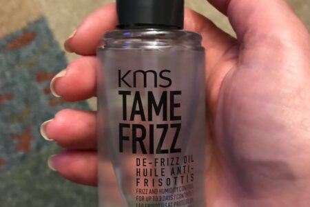 KMS Tame Frizz De-frizz Oil bottle showing the pump, neversaydiebeauty.com