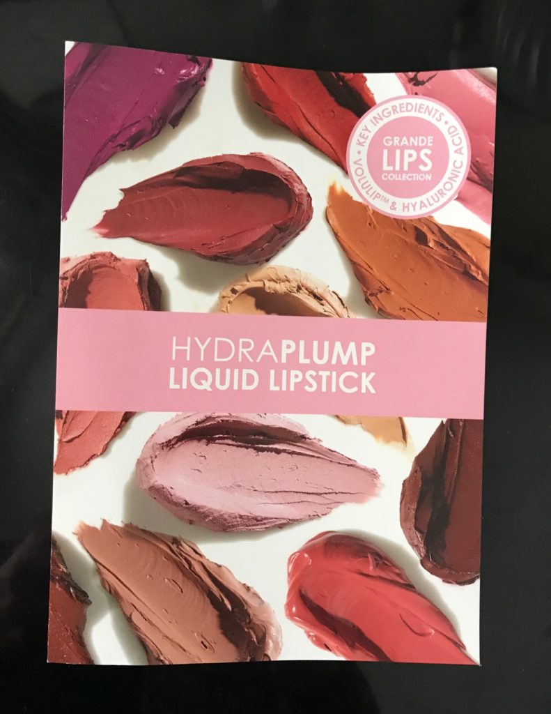 front of the sample card from GrandeLips HydraPlump Liquid Lipstick, neversaydiebeauty.com