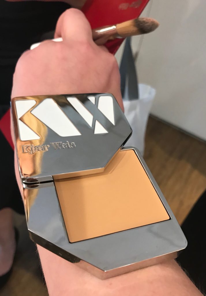 closeup of Kjaer Weis foundation in the silver packaging, neversaydiebeauty.com
