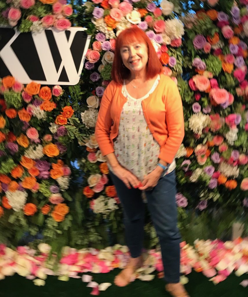 photo of me that's out of focus against a flower wall at the Kjaer Weis launch party at Interlocks Medispa Newburyport MA, neversaydiebeauty.com