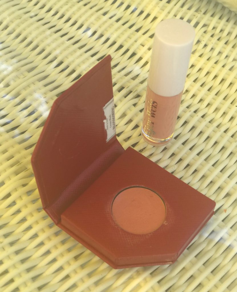 open sample pack of Kjaer Weis cream blush in shade Blossoming, a peachy pink, along with lipgloss sample, neversaydiebeauty.com