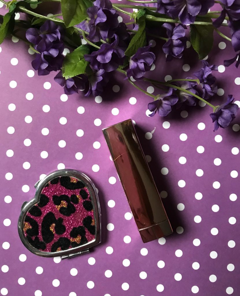 Maybelline Color Sensational Lipstick in a rose gold case along with pink leopard print mirror, neversaydiebeauty.com