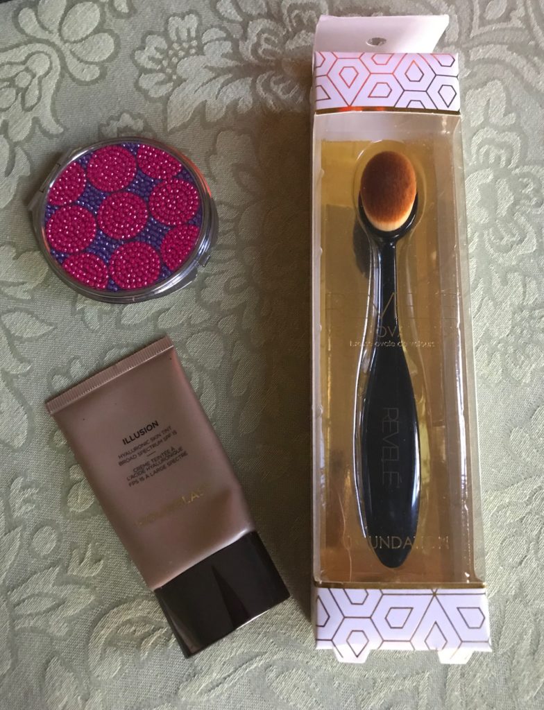 Revele Velvet Oval Brush in its packaging along with my mirror and foundation, neversaydiebeauty.com