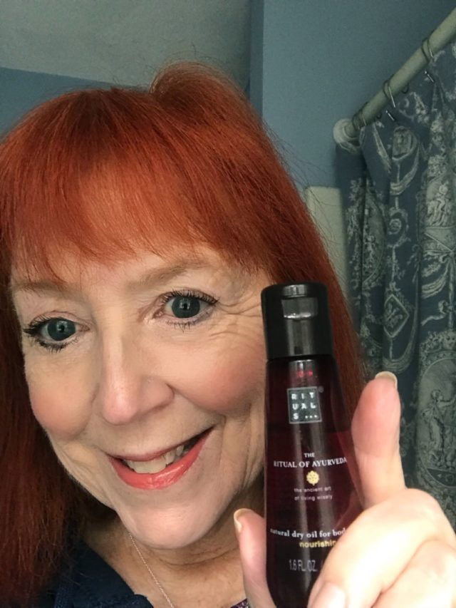 me with a travel size bottle of Rituals Ayurveda Dry Body Oil, neversaydiebeauty.com