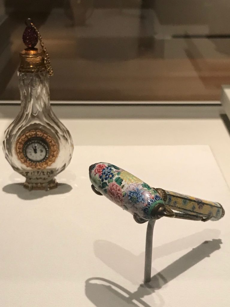 perfume bottle with clock and enameled massage roller made in France owned by Chinese Empress from exhibit at Peabody Essex Museum Salem MA