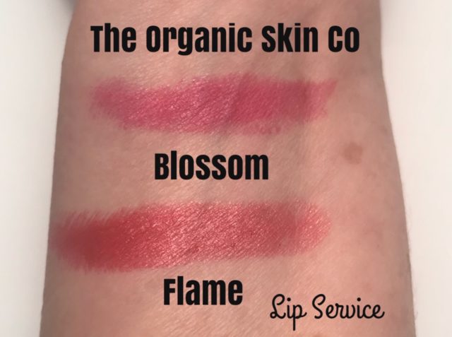swatches The Organic Skin Company Lip Service Lipstick in Blossom, a pink-red, and Flame, a neutral true red, neversaydiebeauty.com