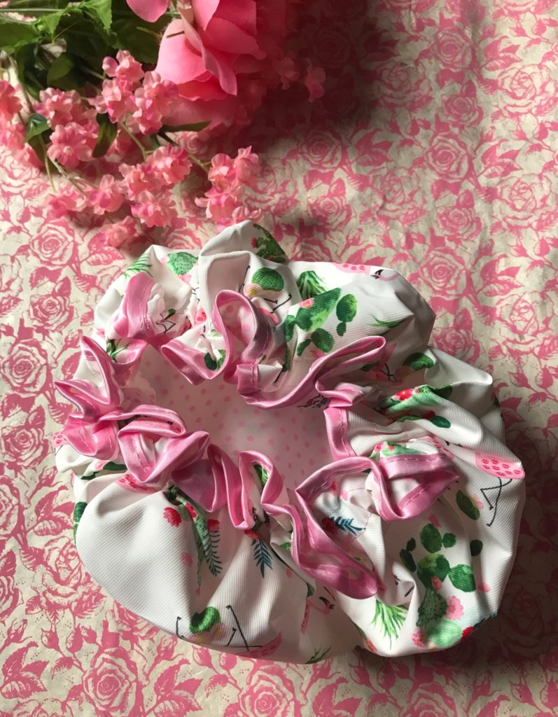 inside the Vintage Cosmetics Co Cactus and Kisses Shower Cap to show the pink trim and the pink polka dot interior, neversaydiebeauty.com