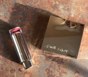 Estee Lauder Pure Color Love Lipstick case and silver Smith & Cult Book of Eyes Palette, neversaydiebeauty.com