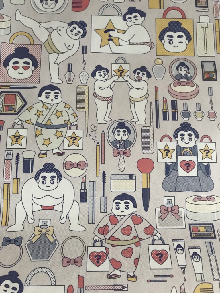 Beautylish wrapping paper for 2019 featuring cartoon drawings of sumo wrestlers and makeup, neversaydiebeauty.com
