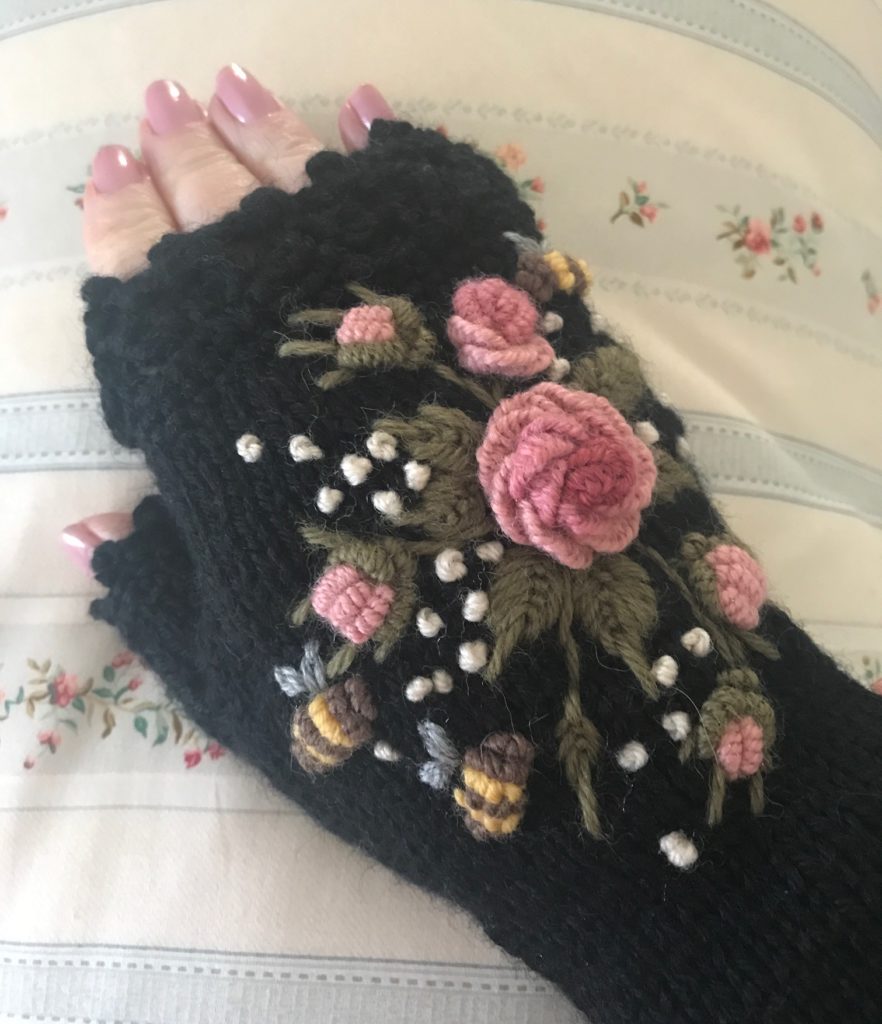 my hand wearing my black wool handmade embroidered fingerless glove, neversaydiebeauty.com