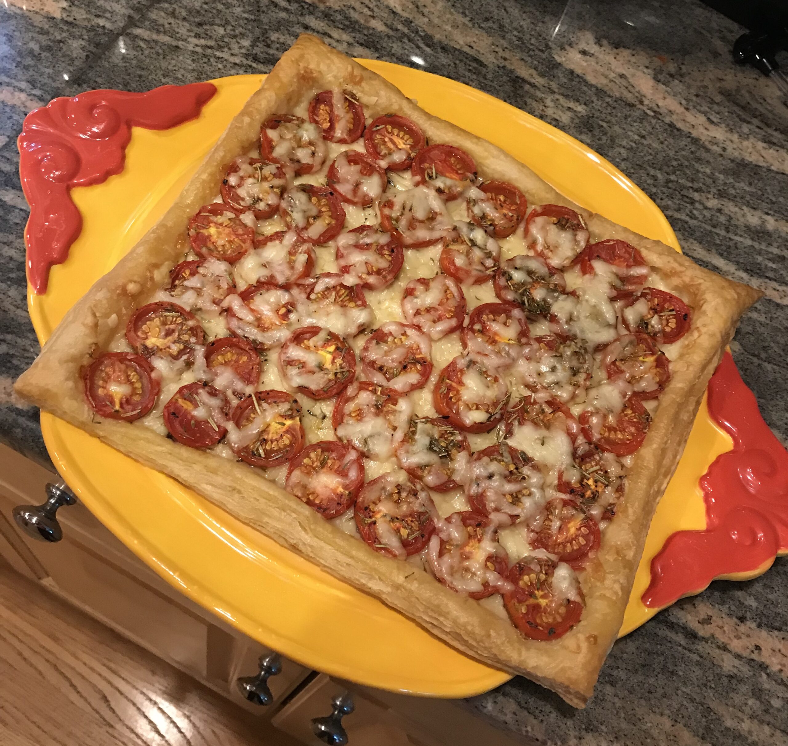 roasted red cherry tomato tart on a yellow and red plate, neversaydiebeauty.com