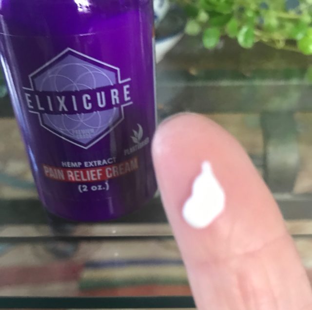 some of the white Elixicure Pain Relief Cream on my finger, neversaydiebeauty.com