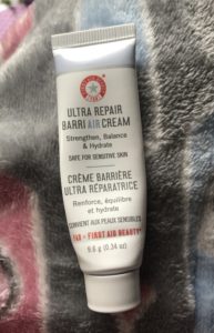 travel size tube of First Aid Beauty Ultra Repair BarriAIR Cream that I used up, neversaydiebeauty.com