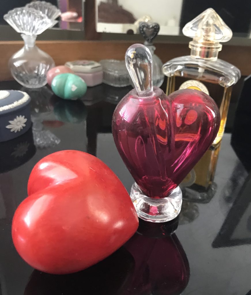 red heart-shaped paperweight and purple glass heart-shaped perfume bottle, neversaydiebeauty.com