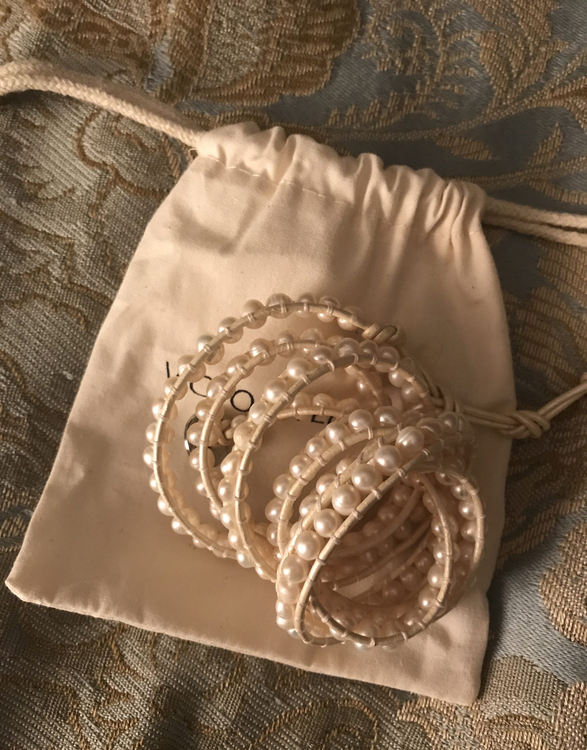 freshwater pearls on ivory leather wrap bracelet on a cotton pouch, neversaydiebeauty.com