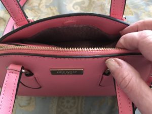 Kate Spade Reiley purse showing the pouch on the outside that closes with a magnetic closure, neversaydiebeauty.com