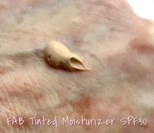 blob of First Aid Beauty Tinted Moisturizer SPF 30 in shade, "Cream", neversaydiebeauty.com